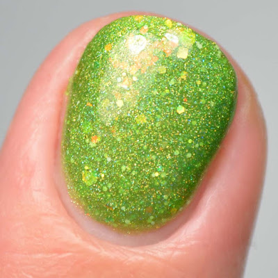 green nail polish with iridescent glitter close up swatch