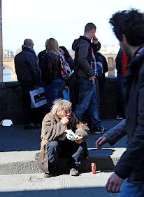 tramp eating on street-side