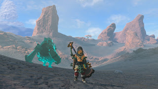 Link and Dark Yunobo back to back with Boulder Breaks, a cherry blossom tree in the distance