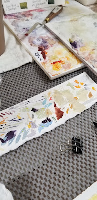 Scrap of watercolor paper with swatches of color samples.