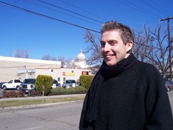 John with blue skies and Capitol Dome