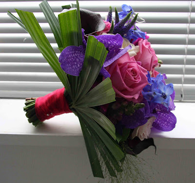 Gemma's wedding bouquet includes Vivid Purple Vanda Orchids 