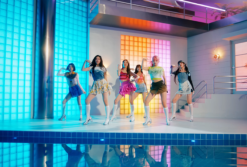 A screenshot of all 6 members of Ive in the music video for “Wave”, dancing in 80s style leisure centre, in front of a swimming pool.