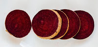 On a white surface are sliced beets with the scarlet red anti-cancer pigments, betacyanin.