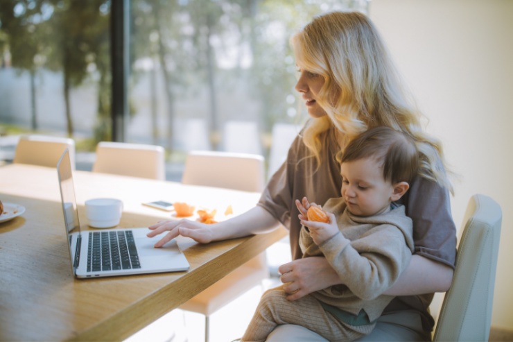 woman working on laptop with baby