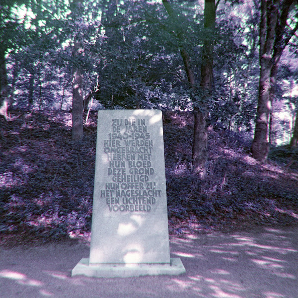 Monument Kamp Amersfoort met opschrift 'Zij die in de jaren 1940-1945 hier werden omgebracht hebben met hun bloed deze grond geheiligd. Hun offer zij het nageslacht een lichtend voorbeeld.'