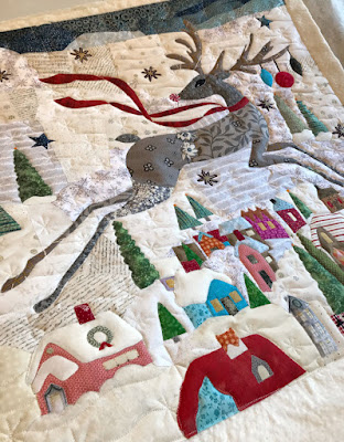 snowdrifts and snowflake quilting on a reindeer quilt