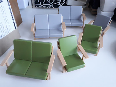 2 sets of one-twelfth scale modern miniature plastic sofas and chairs.