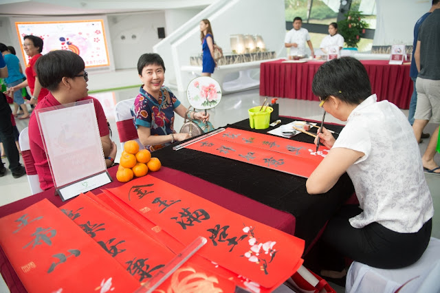 Visitors at the event waiting to get their traditional calligraphy wishes to bring in prosperity in the year of the Rooster