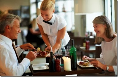 Hospitality - Waitress serving dinner to couple