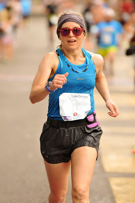 photo of Sarah Pihonak running in a road race straight toward the camera