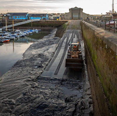 Photo of another view of the digger clearing mud from the slipway