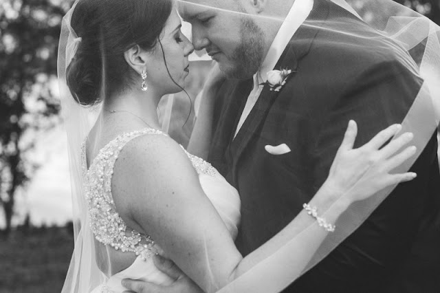 bride and groom caress- black and white