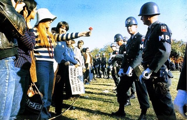 35 moments of violence that brought out incredible human compassion - flower power during the vietnam war protests