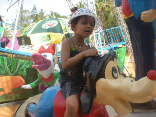 kid riding on goofy a character of mickey mouse