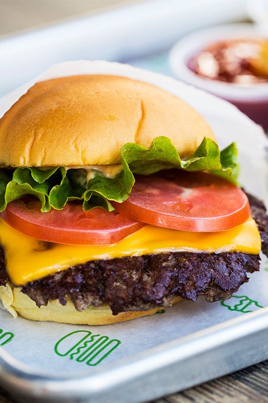 Shake Shack shares the secret recipe for its famous ShackBurger, slathered in ShackSauce and covered in American cheese.