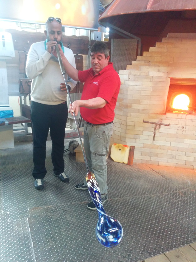 Mouth blowing molten glass into a glass vase at Dorotheenhutte, Germany