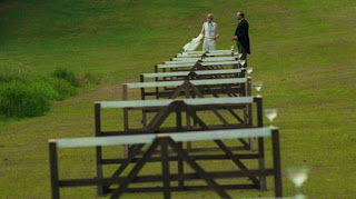 Scene from Chariots of Fire when Nigel Havers goes over hurdles with champagne glasses