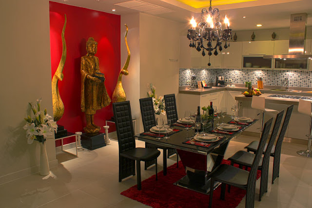 Picture of dining room with black furniture and Budha statue