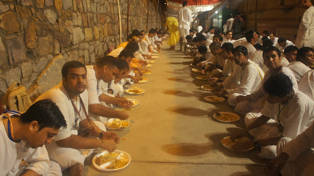 Devotees Taking Krishna Prasadam