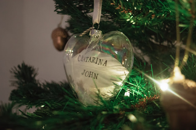 Personalised feather in a glass heart bauble decoration close up