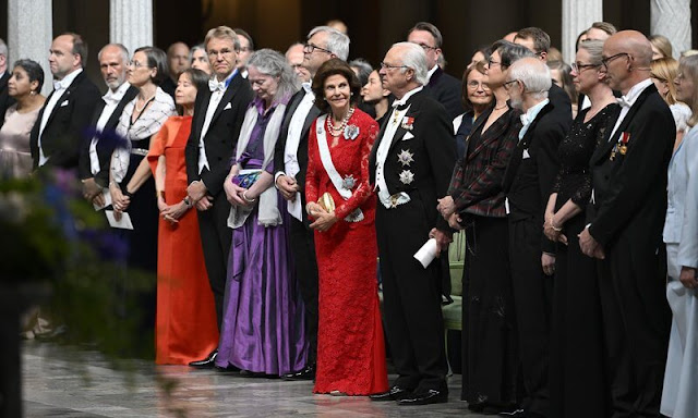 Queen Silvia wore a red lace gown dress. The Sjöberg Prize in Cancer Research. King Carl Gustaf