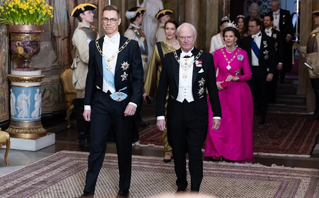 Queen Silvia wore a Padme pink gown by Georg et Arend. Princess Victoria wore a feather cape gown by Toteme