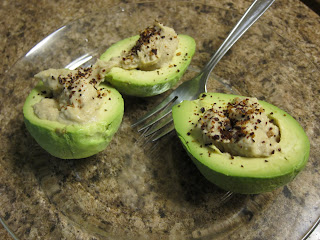 Hummus Filled Avocados With Fork