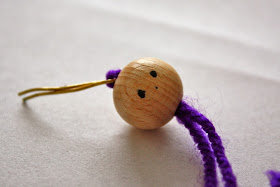 Using wire as a needle , thread a piece of the purple yarn into the ...