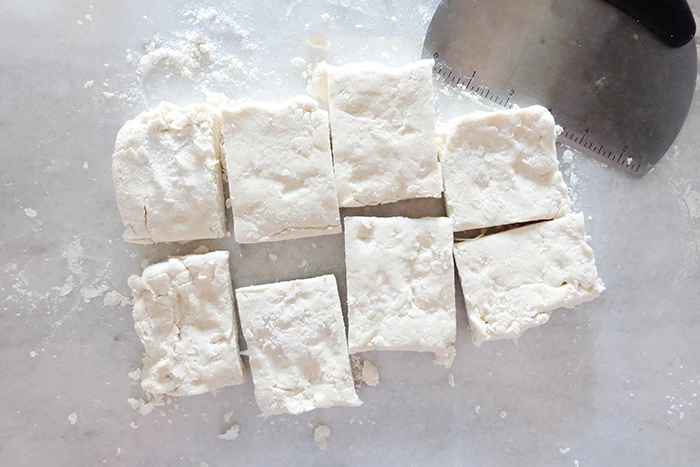 cutting biscuits with dough scraper