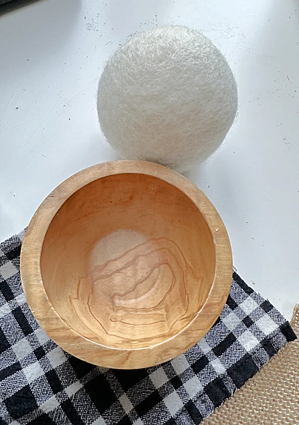 dryer ball, wooden bowl and fabric