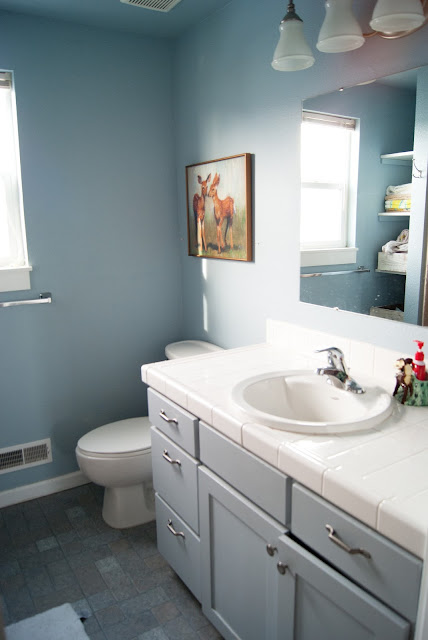 Project Kid's Bathroom Makeover - before & after - new tile, painted vanity, gallery wall, wood shelves and  antler organizers.