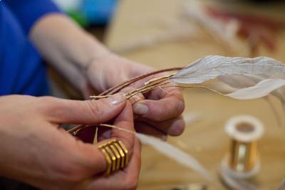 Making a unique headband out of gold wire and feathers