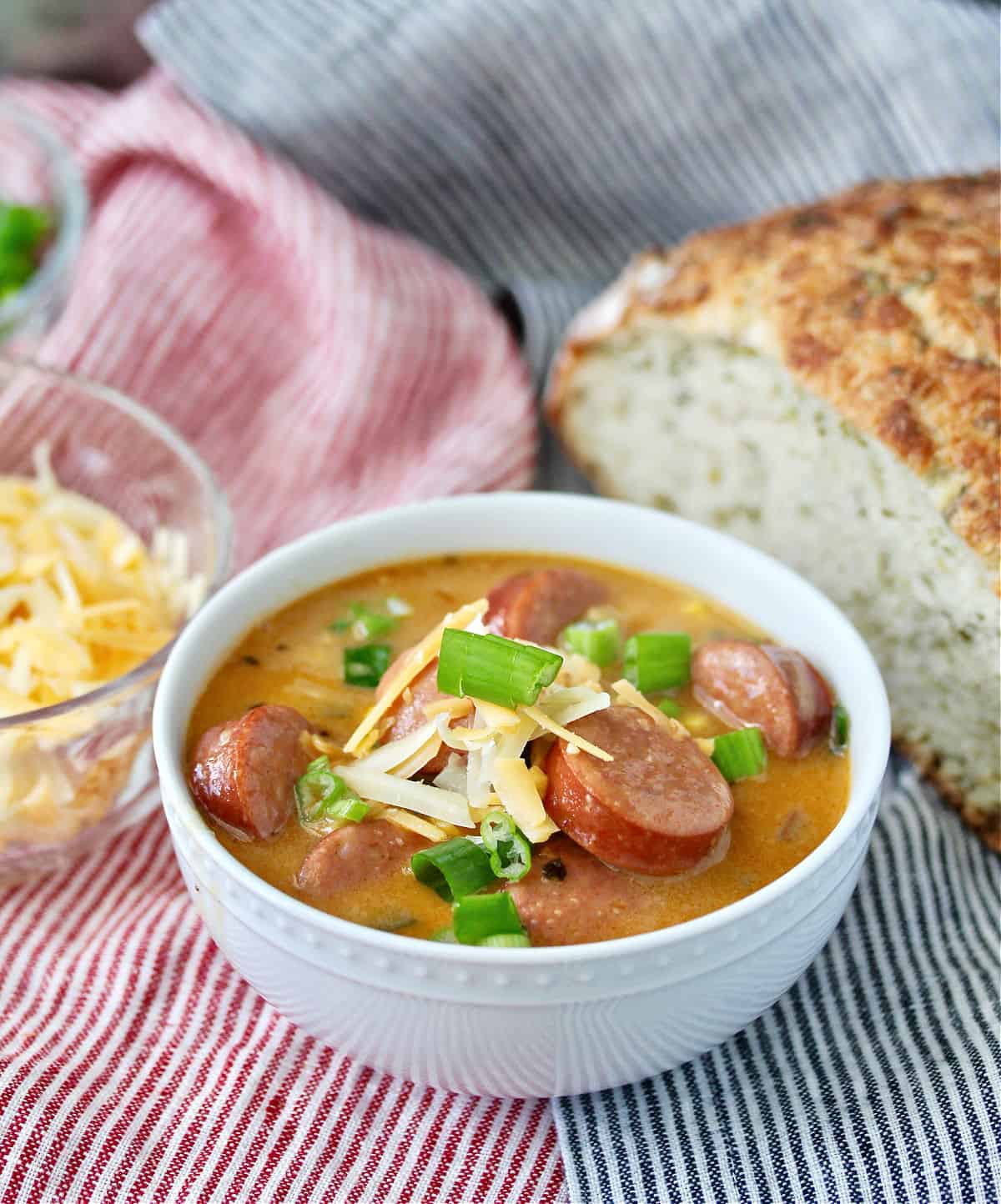 Beer and Smoked Sausage Corn Chowder with a loaf of bread in the background.