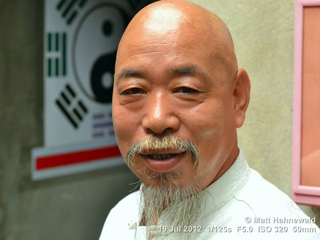 China, Beijing, Chinese man, grey beard, astrologer, people, street portrait, yin-and-yang sign