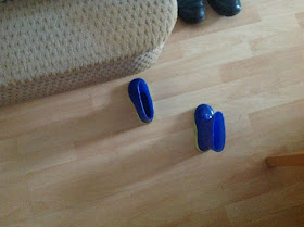 a pair of blue wellies on the floor next to a step