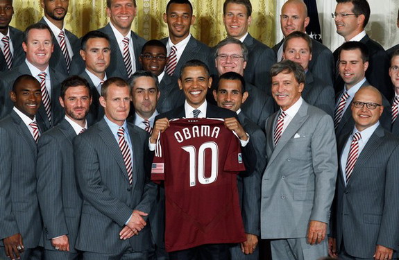 US president Barack Obama holds up a jersey given to him by the MLS champions Colorado Rapids