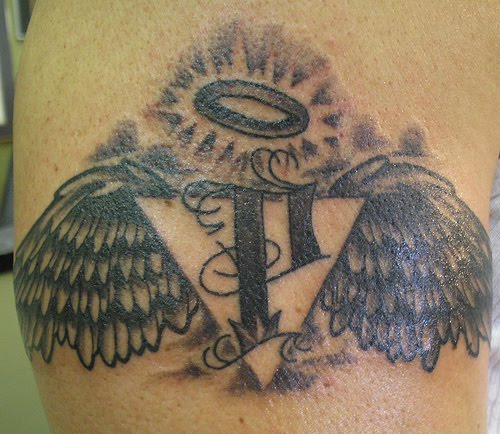 Angel halo tattoo with wings.