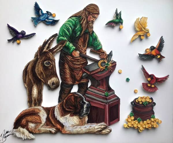 paper quilled portrait of male jewelrysmith at worktable surrounded by animals