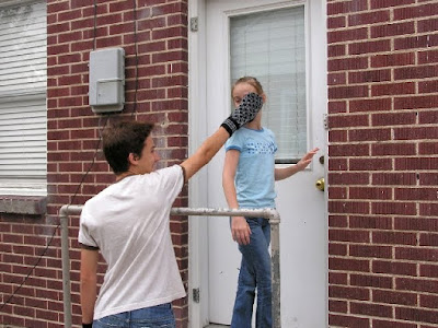 boy attacking girl with mitten