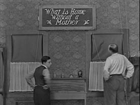Buster Keaton. Scarecrow. What is a home without a mother sign