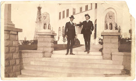 William S Bean of Alameda California standing with another man near steps and pillars with lion statues