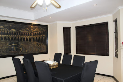 large open-plan tiled lounge leading to dining-room