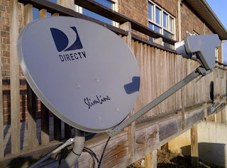 DirecTV satellite dish installed on wood deck