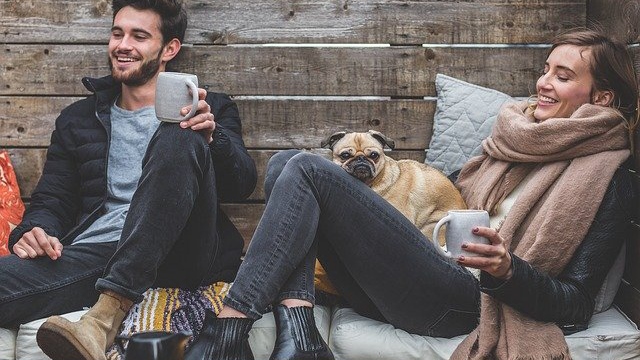 A couple enjoying their winter with the pug