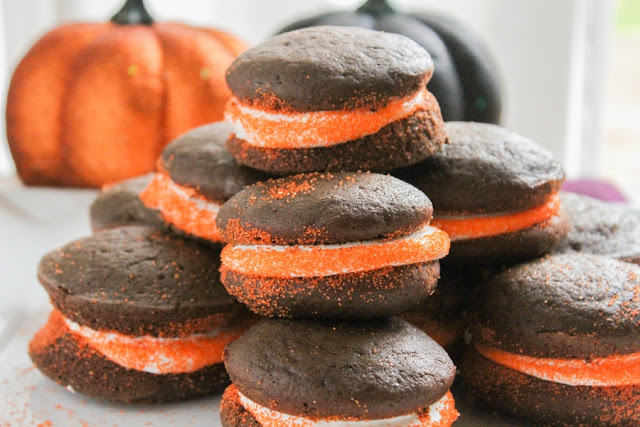 These light and fluffy little chocolate cakes are sandwiched together by a creamy marshmallow buttercream. Adding orange sprinkles to the exposed frosting turns these Halloween Whoopie Pies into a fun and festive treat!