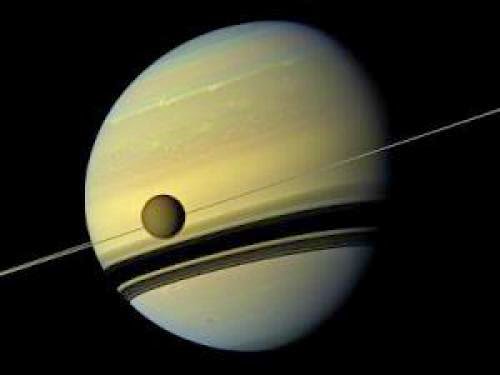 Saturn And Its Largest Moon Reflect Their True Colours