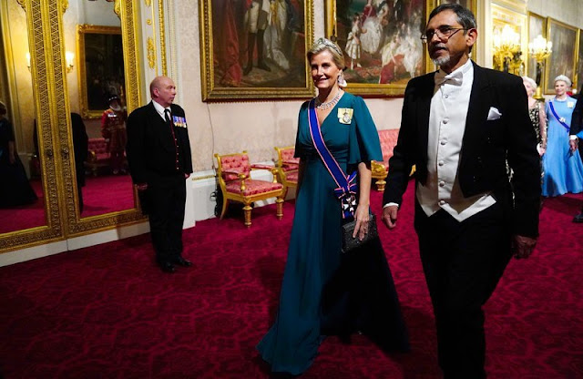 The Princess of Wales wore a Jenny Packham gown and Lover Knot tiara. Queen Consort wearing her Belgium Sapphire Tiara