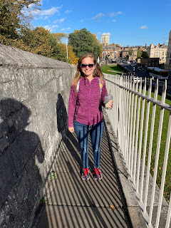 Me holding my milkshake walking along the old stone city walls of York.