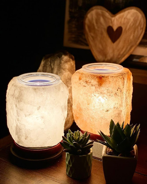 Two himalayan salt lamps working to emit soft glow